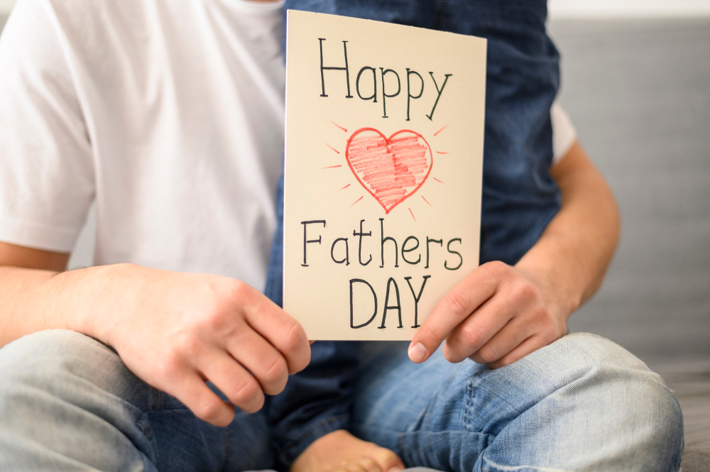 dad holding homemade father's day card